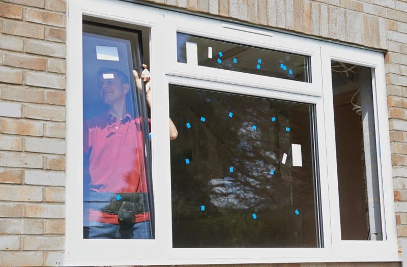 Construction Worker Installing New Windows In House